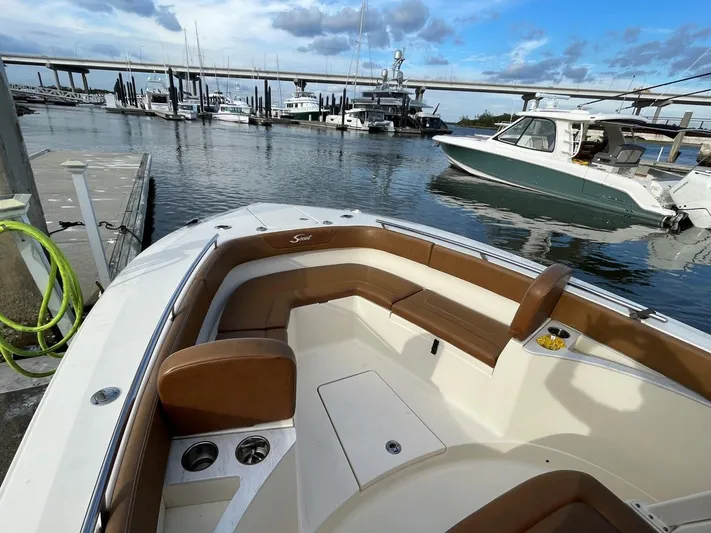  Yacht Photos Pics 2020 Ocean Scout 277 boat docked in marina, featuring spacious seating and scenic waterfront view.