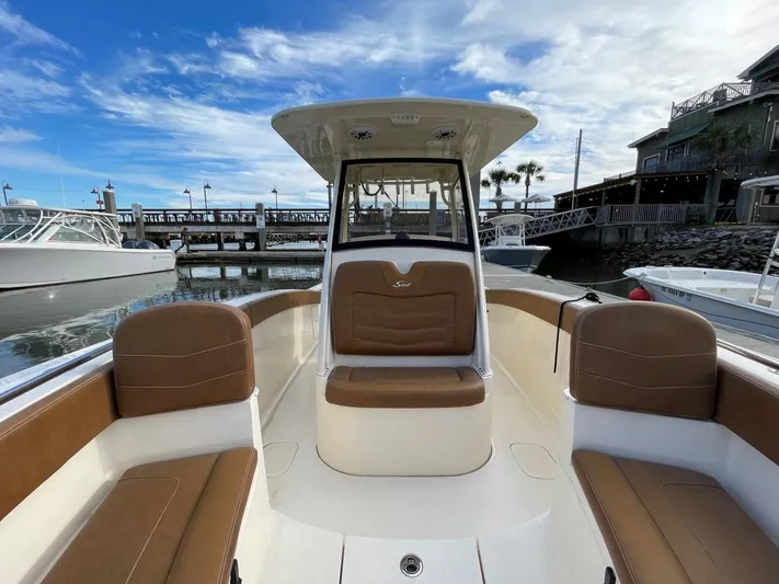  Yacht Photos Pics 2020 Ocean Scout 277 boat with brown seating, docked at marina under blue sky.
