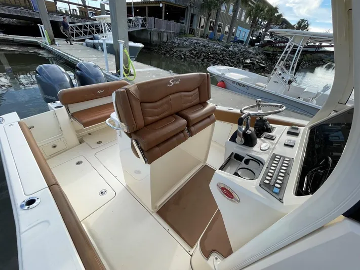  Yacht Photos Pics 2020 Ocean Scout 277 boat interior with dual seats and control panel at dock.