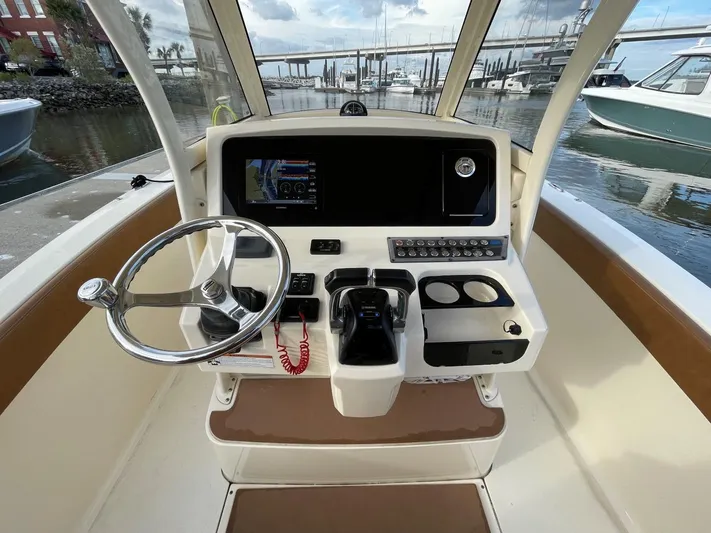  Yacht Photos Pics 2020 Ocean Scout 277 boat helm with steering wheel and control panel.