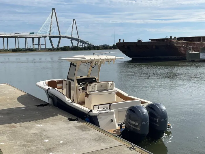  Yacht Photos Pics 2020 Ocean Scout 277 boat docked near a bridge with twin Yamaha engines.