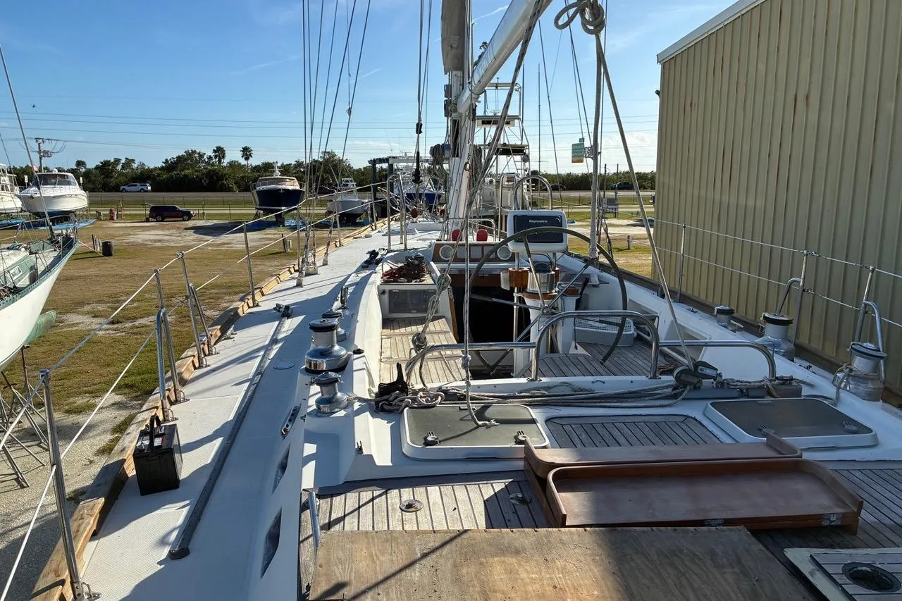 Deck view of a 1998 Tayana 55 sailboat in a marina, showcasing rigging and equipment.