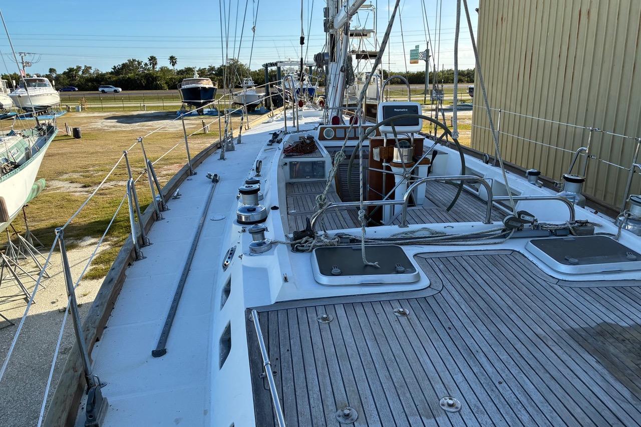 1998 Tayana 55 sailboat deck with wooden finish, docked in a marina.