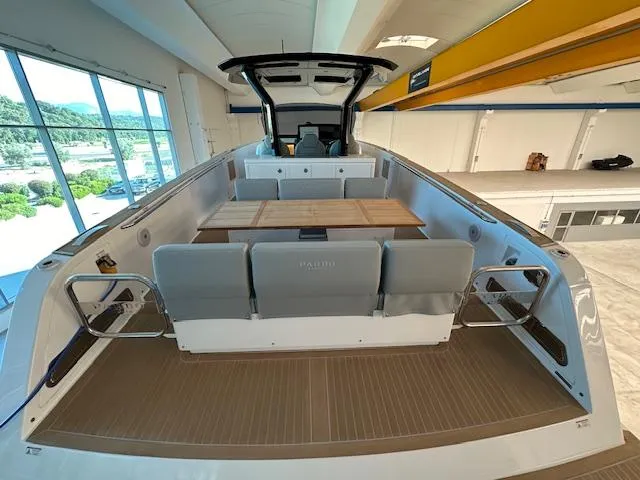 Pardo 38 Yacht Photos Pics 2023 Pardo Yachts 38 interior with sleek seating and wooden table in a showroom.
