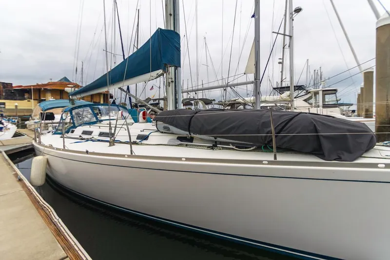 Lark Yacht Photos Pics 2001 J Boats 46 sailboat docked at marina, featuring blue sail cover.