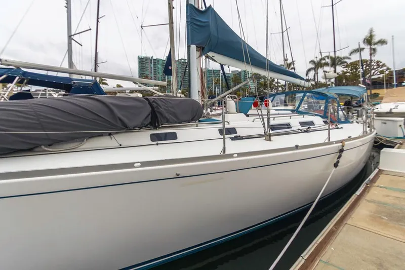Lark Yacht Photos Pics 2001 J Boats 46 sailboat docked at marina with blue sail cover.