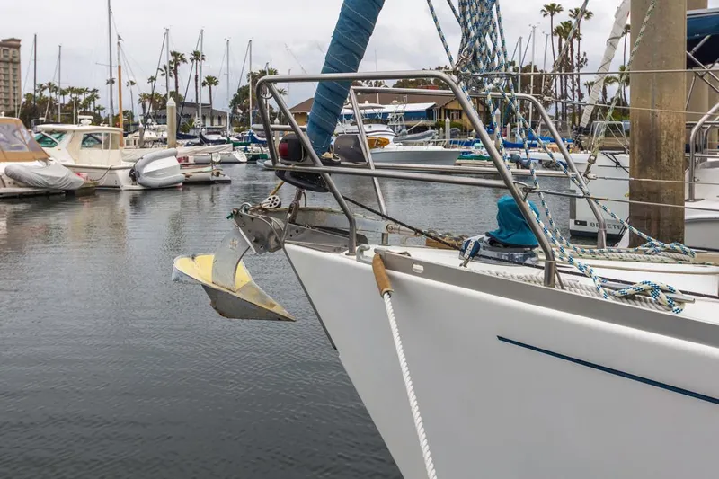 Lark Yacht Photos Pics Sailboat J Boats 46 (2001) docked in marina, surrounded by other boats.