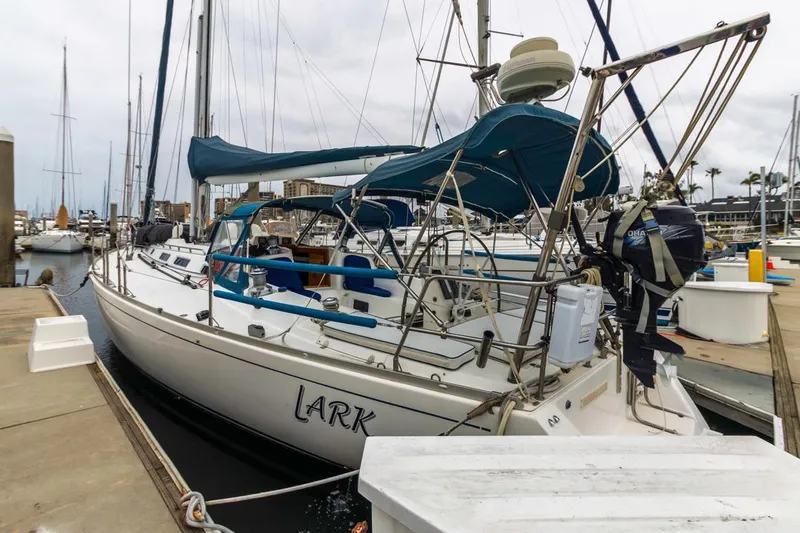 Lark Yacht Photos Pics 2001 J Boats 46 sailboat docked at marina with blue canopy and equipment.