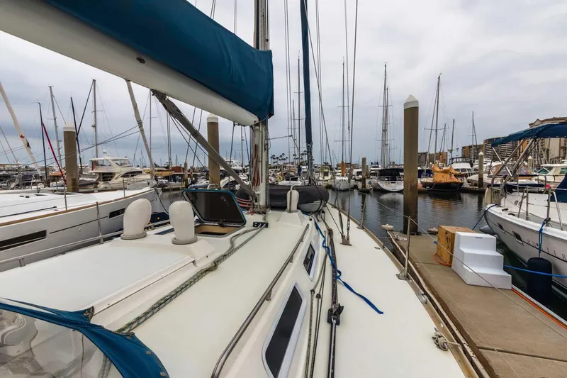 Lark Yacht Photos Pics Sailboat docked in marina, J Boats 46, 2001 model, surrounded by other vessels.