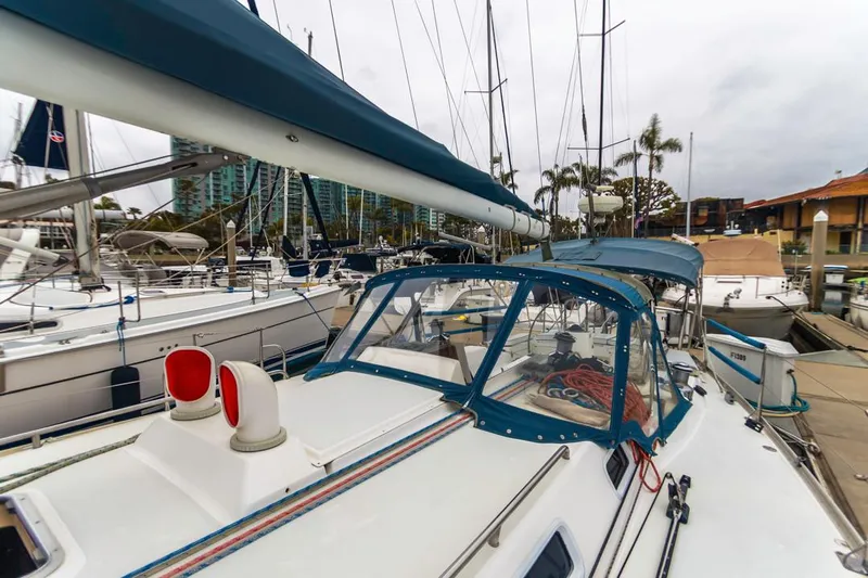 Lark Yacht Photos Pics 2001 J Boats 46 sailboat docked in marina, surrounded by other vessels.