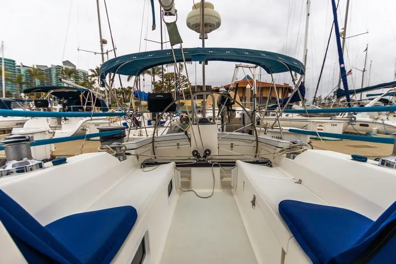 Lark Yacht Photos Pics 2001 J Boats 46 sailboat with blue seating, docked in a marina.