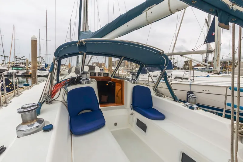 Lark Yacht Photos Pics 2001 J Boats 46 sailboat cockpit with blue cushions, docked in a marina.
