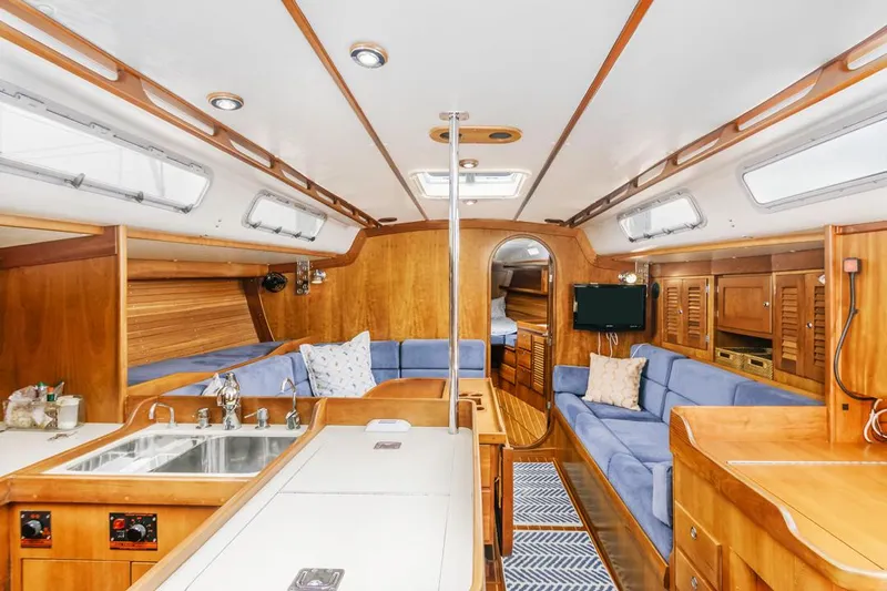 Lark Yacht Photos Pics Interior of 2001 J Boats 46 yacht with wood finish and blue seating.