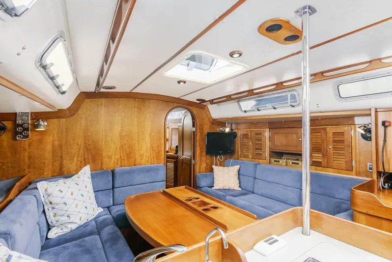Lark Yacht Photos Pics Interior of 2001 J Boats 46 sailboat with blue seating and wooden finishes.