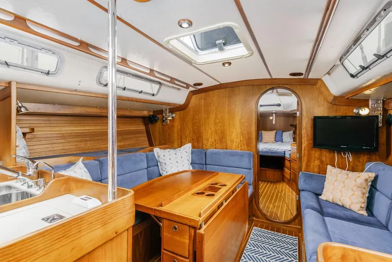 Lark Yacht Photos Pics Interior of 2001 J Boats 46 yacht with wood finish and blue seating.