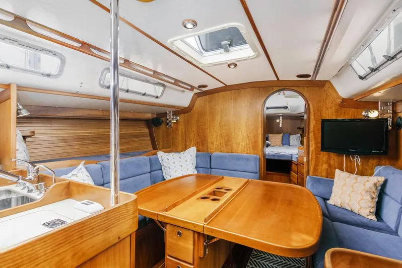 Lark Yacht Photos Pics Interior of 2001 J Boats 46 sailboat with wood finish and blue seating.