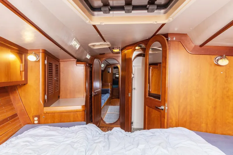Lark Yacht Photos Pics Interior of 2001 J Boats 46 yacht with wooden cabinetry and cozy sleeping area.