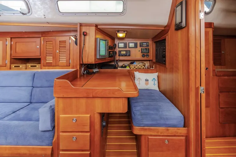 Lark Yacht Photos Pics Interior of 2001 J Boats 46 sailboat with wooden cabinetry and blue seating.