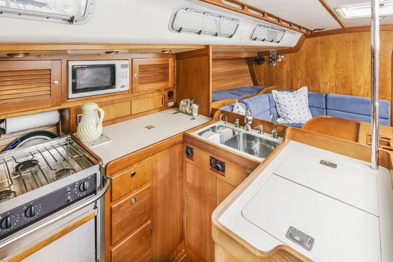 Lark Yacht Photos Pics Interior of 2001 J Boats 46 yacht with kitchen and seating area.