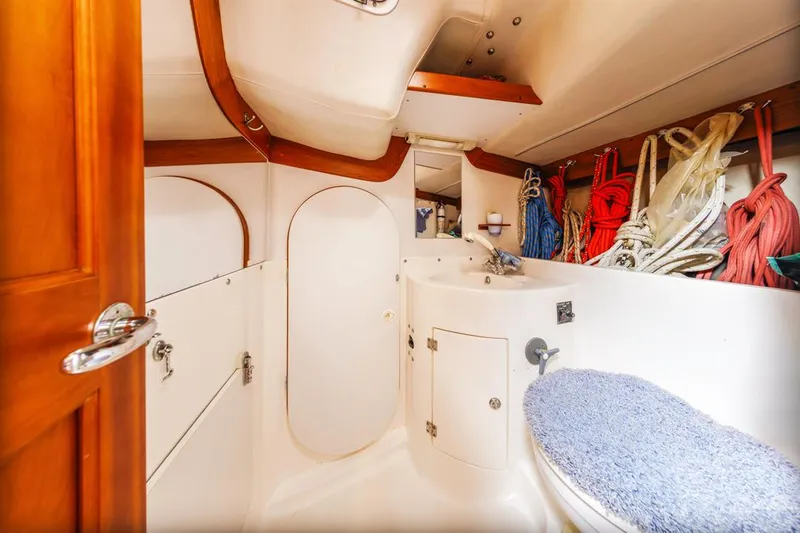 Lark Yacht Photos Pics Interior of 2001 J Boats 46 yacht bathroom with storage and nautical decor.