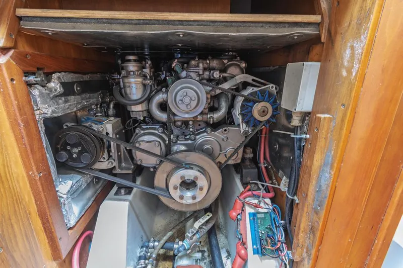 Lark Yacht Photos Pics Engine compartment of a 2001 J Boats 46 sailboat, showcasing mechanical components and wiring.