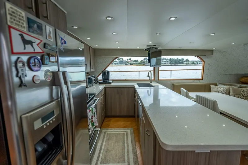 Lady Helen Yacht Photos Pics Luxurious kitchen interior on a 1982 Broward 87 yacht with modern appliances and waterfront views.