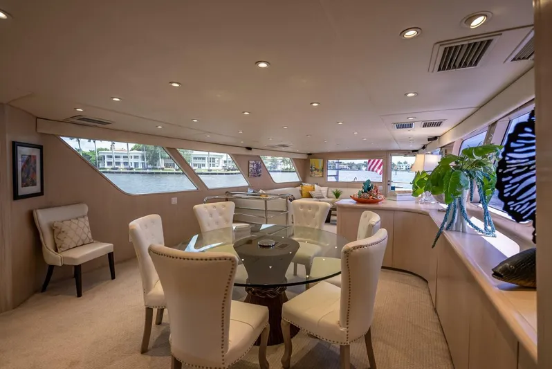 Lady Helen Yacht Photos Pics Luxurious interior of 1982 Broward 87 yacht with elegant seating and large windows.