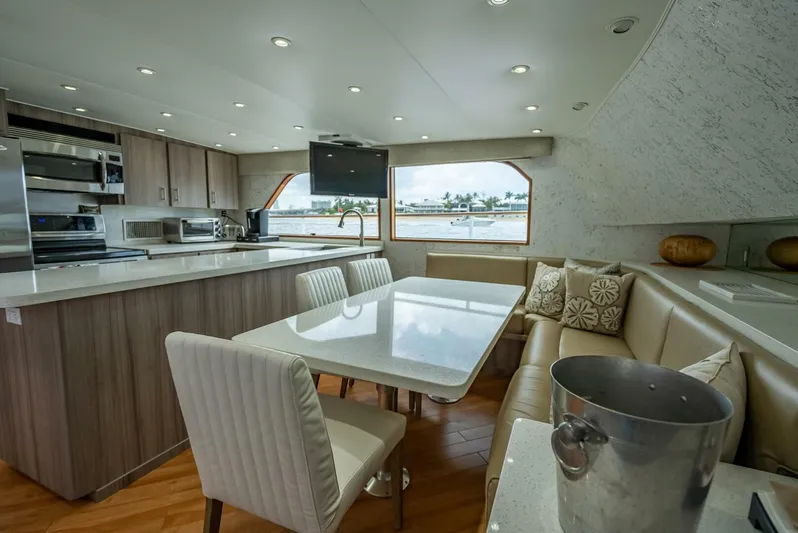Lady Helen Yacht Photos Pics Luxurious 1982 Broward 87 yacht interior with modern kitchen and dining area.