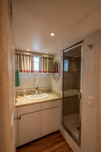 Lady Helen Yacht Photos Pics Bathroom interior of 1982 Broward 87 yacht with sink and shower.