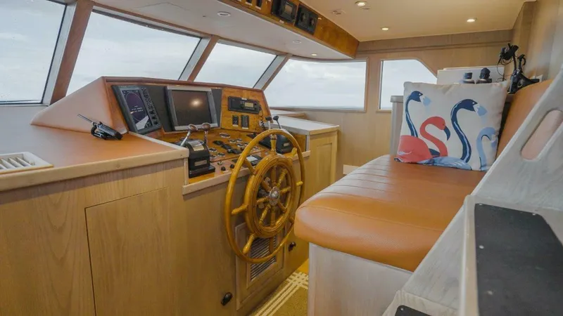 Lady Helen Yacht Photos Pics Helm of 1982 Broward 87 yacht with wooden wheel and navigation equipment.