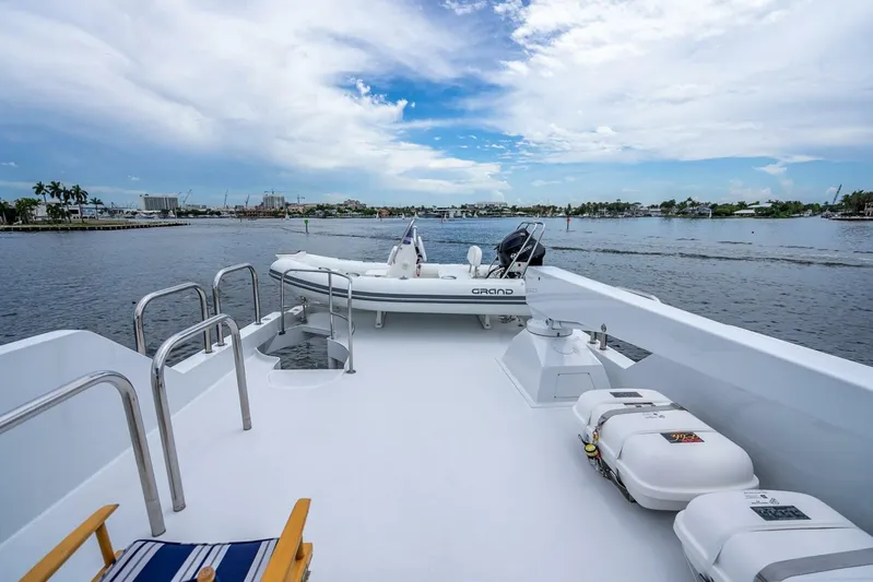 Lady Helen Yacht Photos Pics Deck view of 1982 Broward 87 yacht with inflatable boat and scenic waterfront.