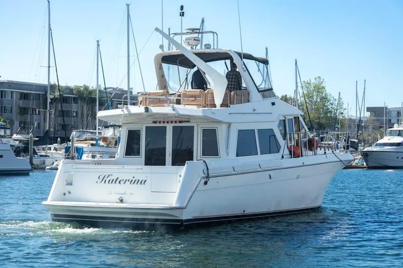 Katerina Yacht Photos Pics 1996 Navigator 5300 Classic yacht in marina, surrounded by other boats and buildings.