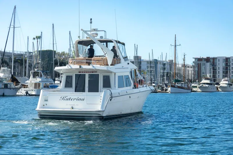 Katerina Yacht Photos Pics Navigator 5300 Classic yacht from 1996 cruising in a marina with sailboats.