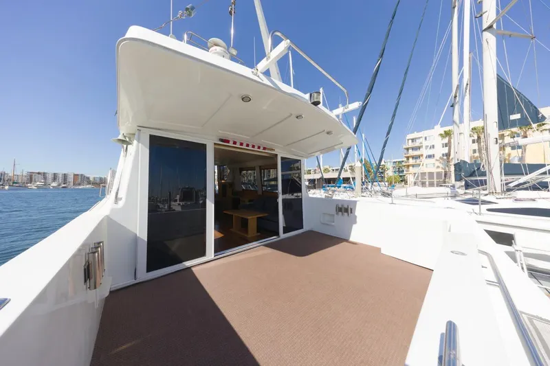 Katerina Yacht Photos Pics 1996 Navigator 5300 Classic yacht with spacious deck, docked in a sunny marina.