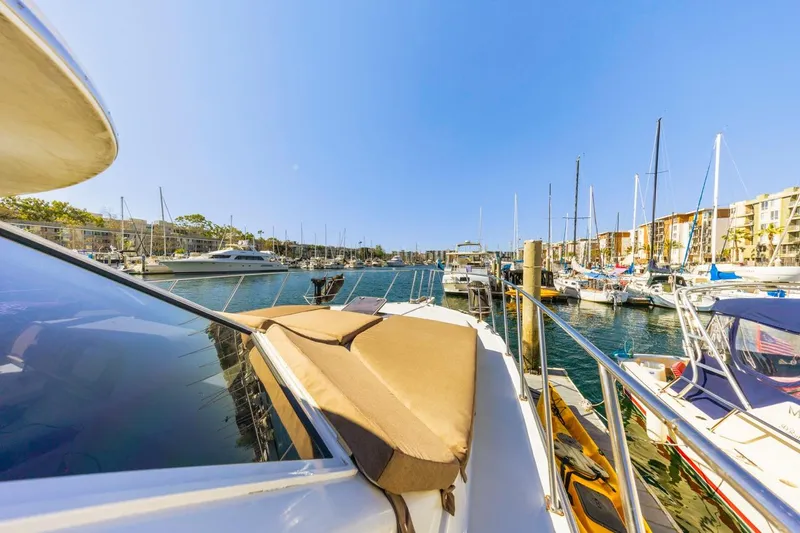 Katerina Yacht Photos Pics 1996 Navigator 5300 Classic yacht docked in a sunny marina, surrounded by sailboats.