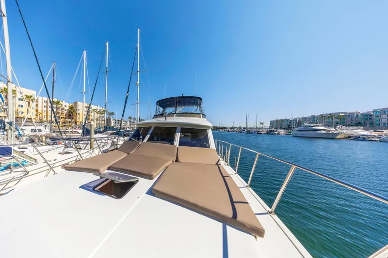 Katerina Yacht Photos Pics 1996 Navigator 5300 Classic yacht docked in a sunny marina, surrounded by sailboats.