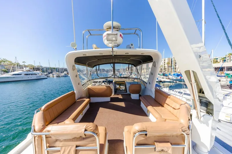 Katerina Yacht Photos Pics Navigator 5300 Classic 1996 yacht with spacious deck and seating, docked in a marina.