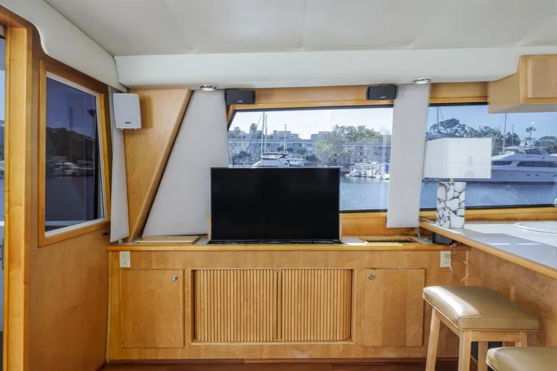 Katerina Yacht Photos Pics Interior of 1996 Navigator 5300 Classic yacht with TV, windows, and wooden cabinetry.