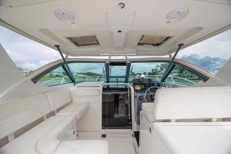 Knot On Call Yacht Photos Pics Interior view of 2004 Tiara Yachts 3200 Open, featuring helm and seating area.