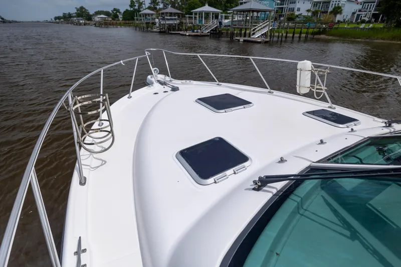 Knot On Call Yacht Photos Pics 2004 Tiara Yachts 3200 Open on calm water, showcasing sleek deck design and hatches.