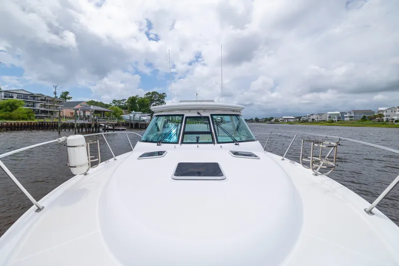 Knot On Call Yacht Photos Pics 2004 Tiara Yachts 3200 Open cruising on a scenic waterway under cloudy skies.