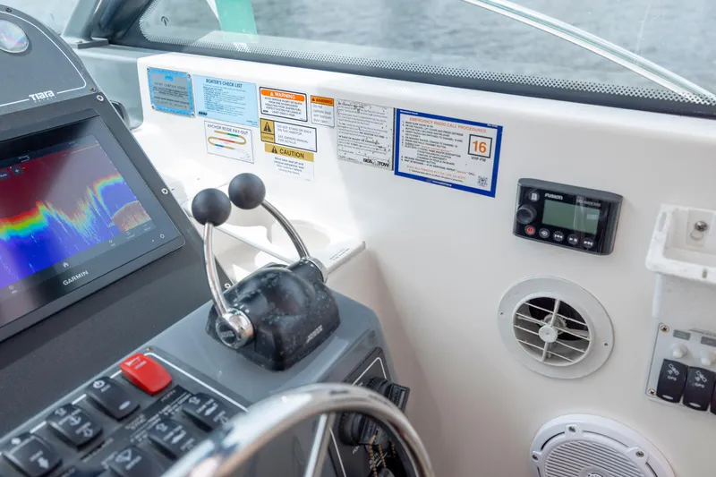 Knot On Call Yacht Photos Pics 2004 Tiara Yachts 3200 Open helm with Garmin display and control panel.