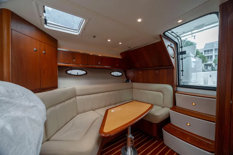 Knot On Call Yacht Photos Pics Luxurious interior of 2004 Tiara Yachts 3200 Open with elegant wood finish and plush seating.