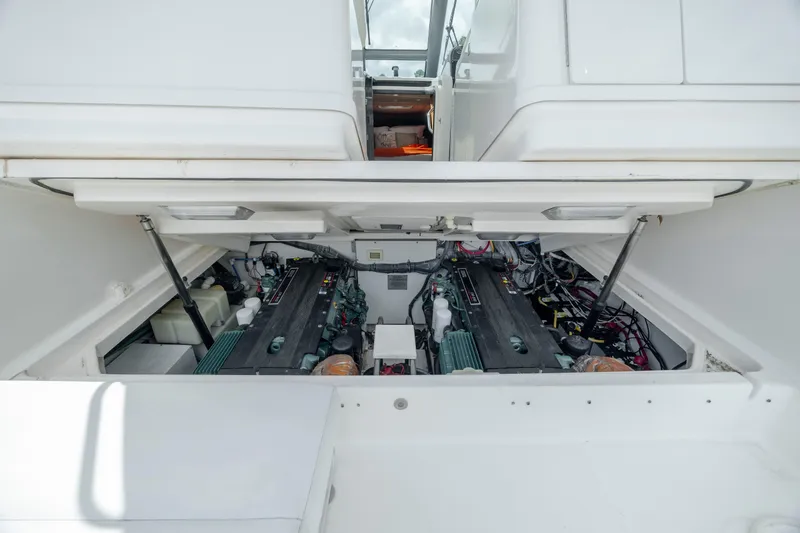 Knot On Call Yacht Photos Pics Engine compartment of 2004 Tiara Yachts 3200 Open, showcasing dual engines and mechanical components.