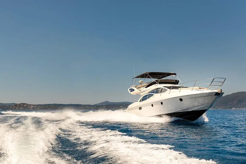  Yacht Photos Pics Luxury 2008 Azimut 43 yacht cruising on open sea under clear blue sky.