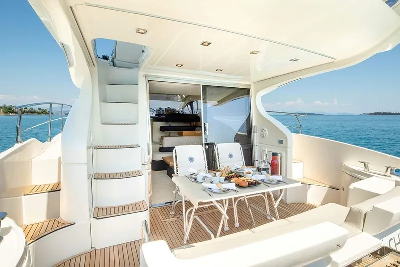  Yacht Photos Pics Luxurious 2008 Azimut 43 yacht interior with elegant dining setup and ocean view.