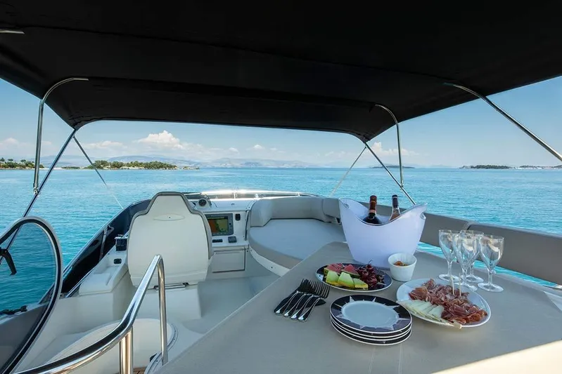  Yacht Photos Pics Luxurious 2008 Azimut 43 yacht with elegant dining setup on serene blue waters.