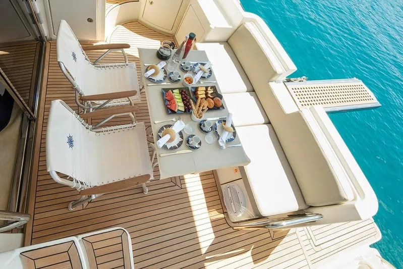  Yacht Photos Pics Luxury dining setup on 2008 Azimut 43 yacht, overlooking turquoise waters.