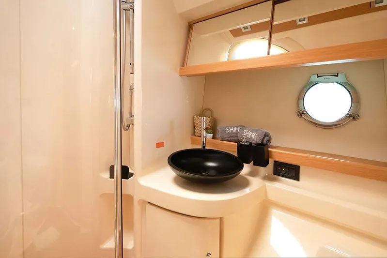  Yacht Photos Pics Luxurious bathroom interior of 2008 Azimut 43 yacht with modern sink and porthole window.