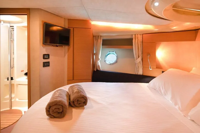  Yacht Photos Pics Luxurious cabin interior of 2008 Azimut 43 yacht with cozy bed and porthole view.
